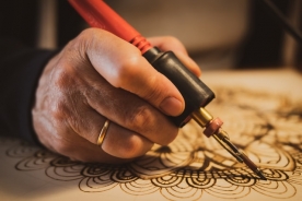 What is pyrography and how can I use it to decorate my wooden gift boxes?
